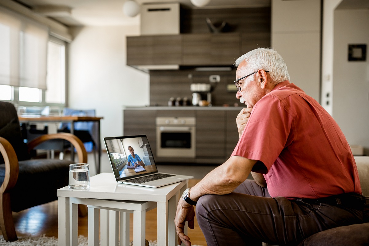 Senior White Man at home having video call with doctor