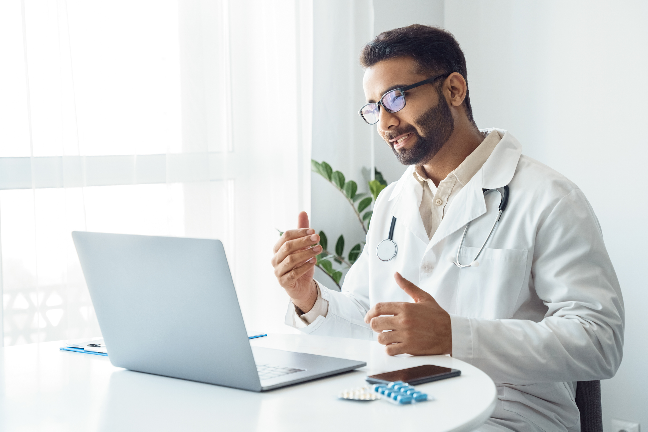 Male doctor having virtual visit with patient