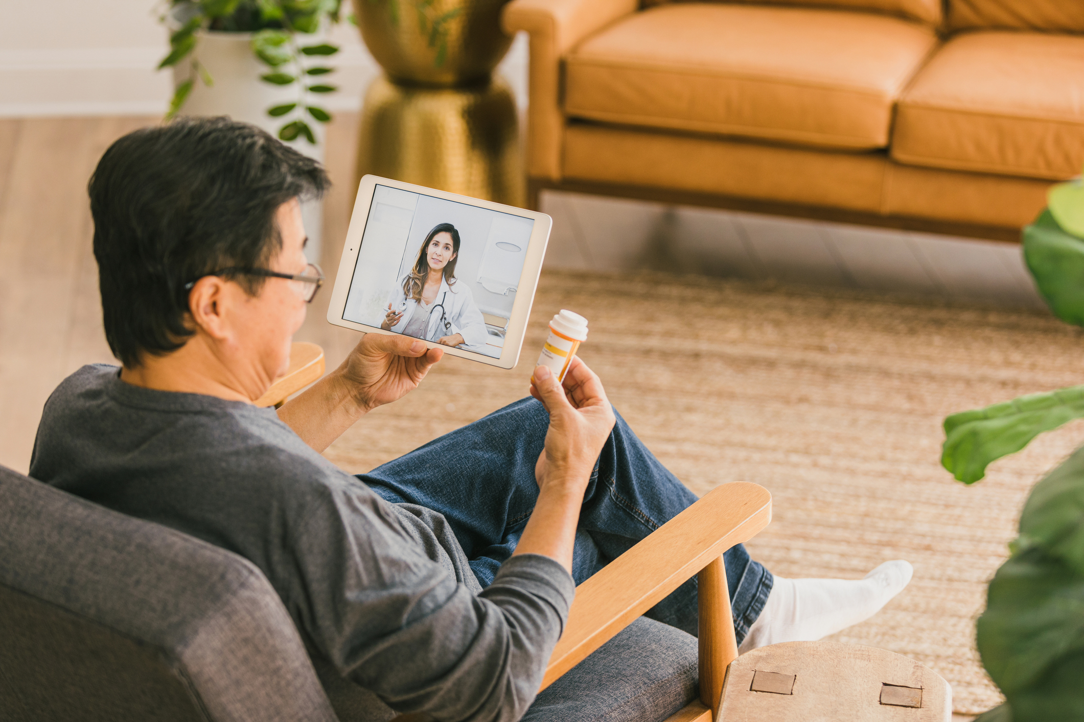 Asian man having virtual visit to discuss prescription