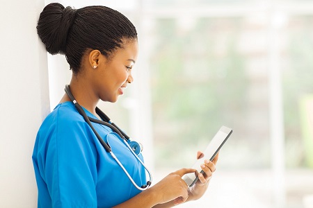 black female nurse using tablet