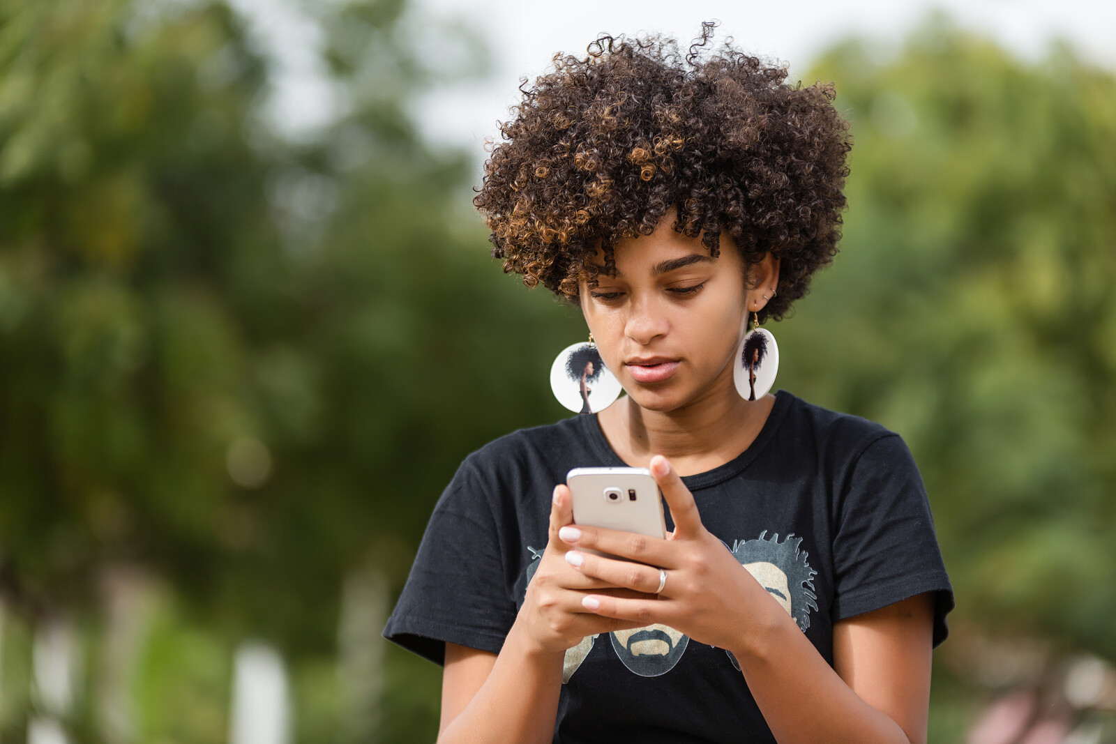 Female African American teenager texting on Smartphone