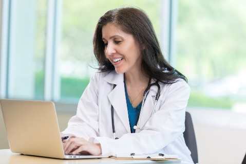 Female doctor typing on laptop 