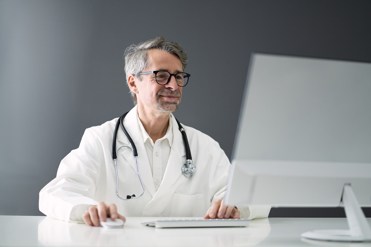 Doctor looking at a desktop computer